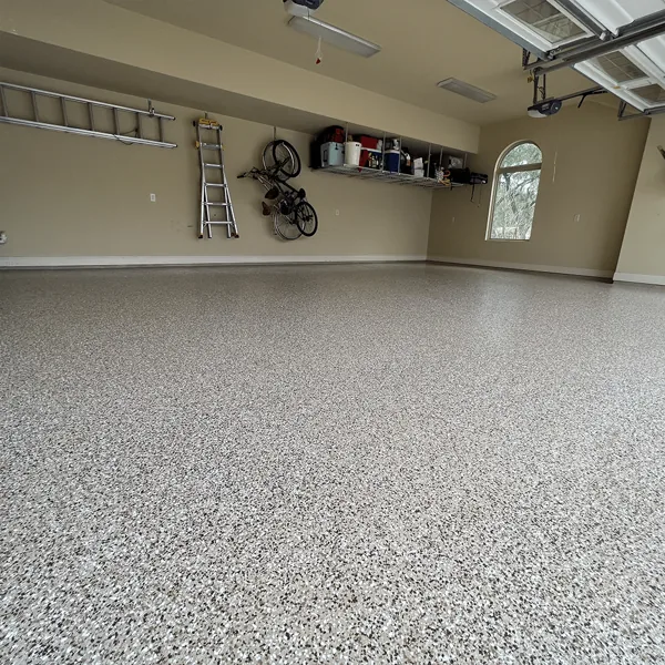 Clean garage interior with gray flake epoxy flooring