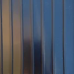 Close-up of black garage flooring featuring a parallel ribbed texture.