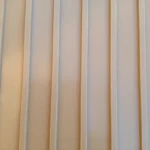 Close-up of sandstone-colored garage flooring with a parallel ribbed pattern.