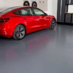 Grey diamond tread garage flooring with a red Tesla parked in a garage