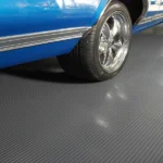 Grey ribbed pattern garage flooring shown beneath the wheel