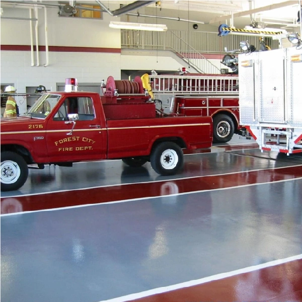 High-Traffic Vehicle Zones--Fire trucks in a station with glossy epoxy floors