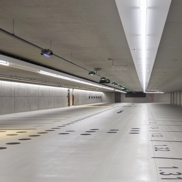 Office building parking basements--Empty underground parking garage with bright LED lights