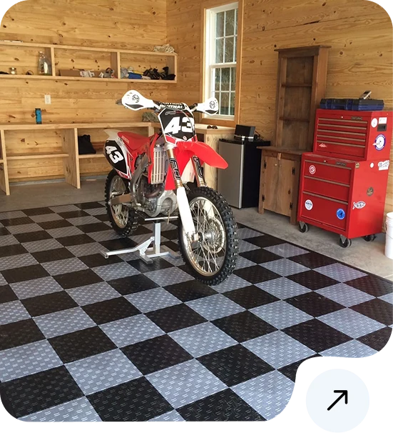 black and gray diamond plate interlocking tiles in a garage workspace.