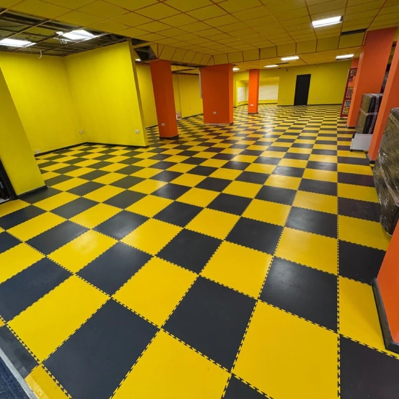 Checkered PVC garage flooring tiles in a showroom.