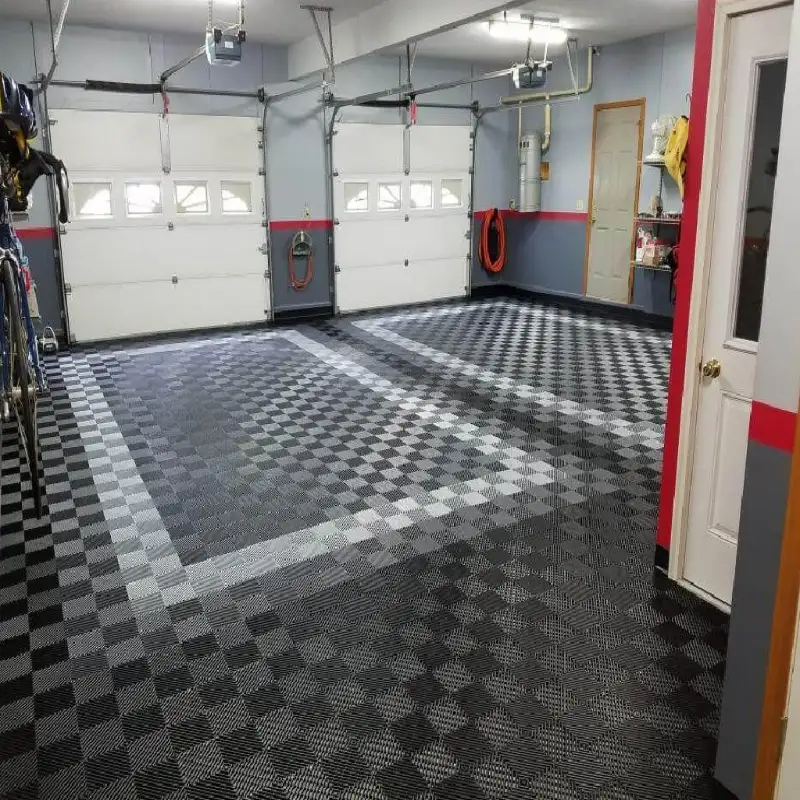 Custom garage tile flooring featuring a grey and black checkerboard pattern with a solid grey border