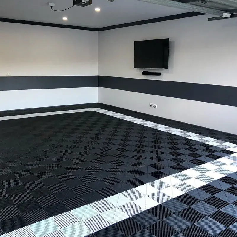 Dark gray garage tiles with white perimeter border.