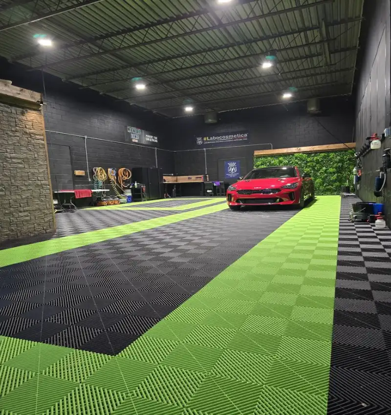 Durable rubber garage flooring with a unique zigzag mats design in black and lime green