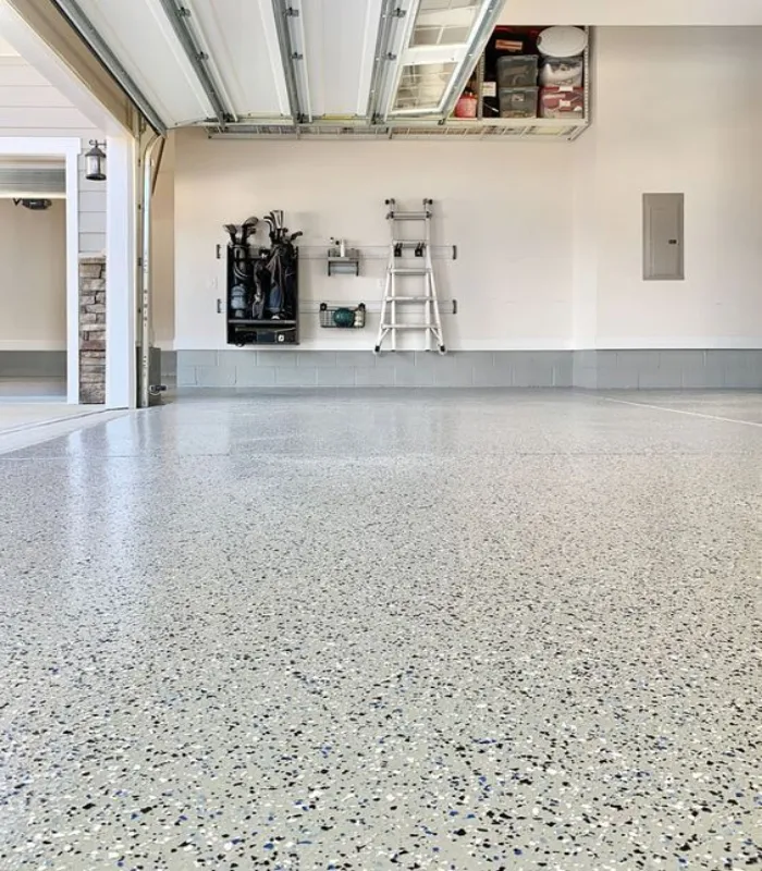 Durable speckled epoxy garage flooring installed in a clean home garage