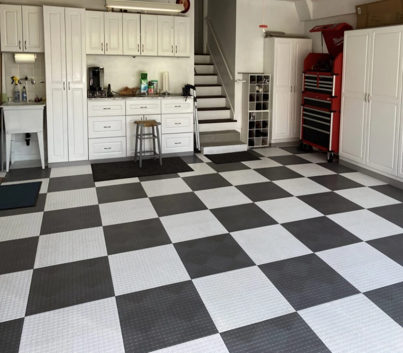 High-quality garage tile flooring featuring a grey and white checkerboard coin-top pattern