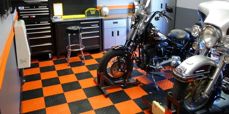 Studded orange and black PVC garage flooring for motorcycle